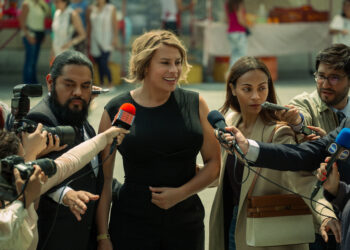 a woman being interviewed by the news