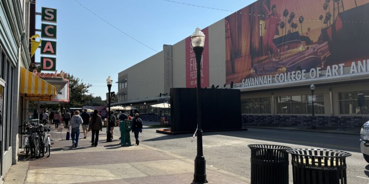 a sign on a building celebrating the SCAD Savannah Film Festival