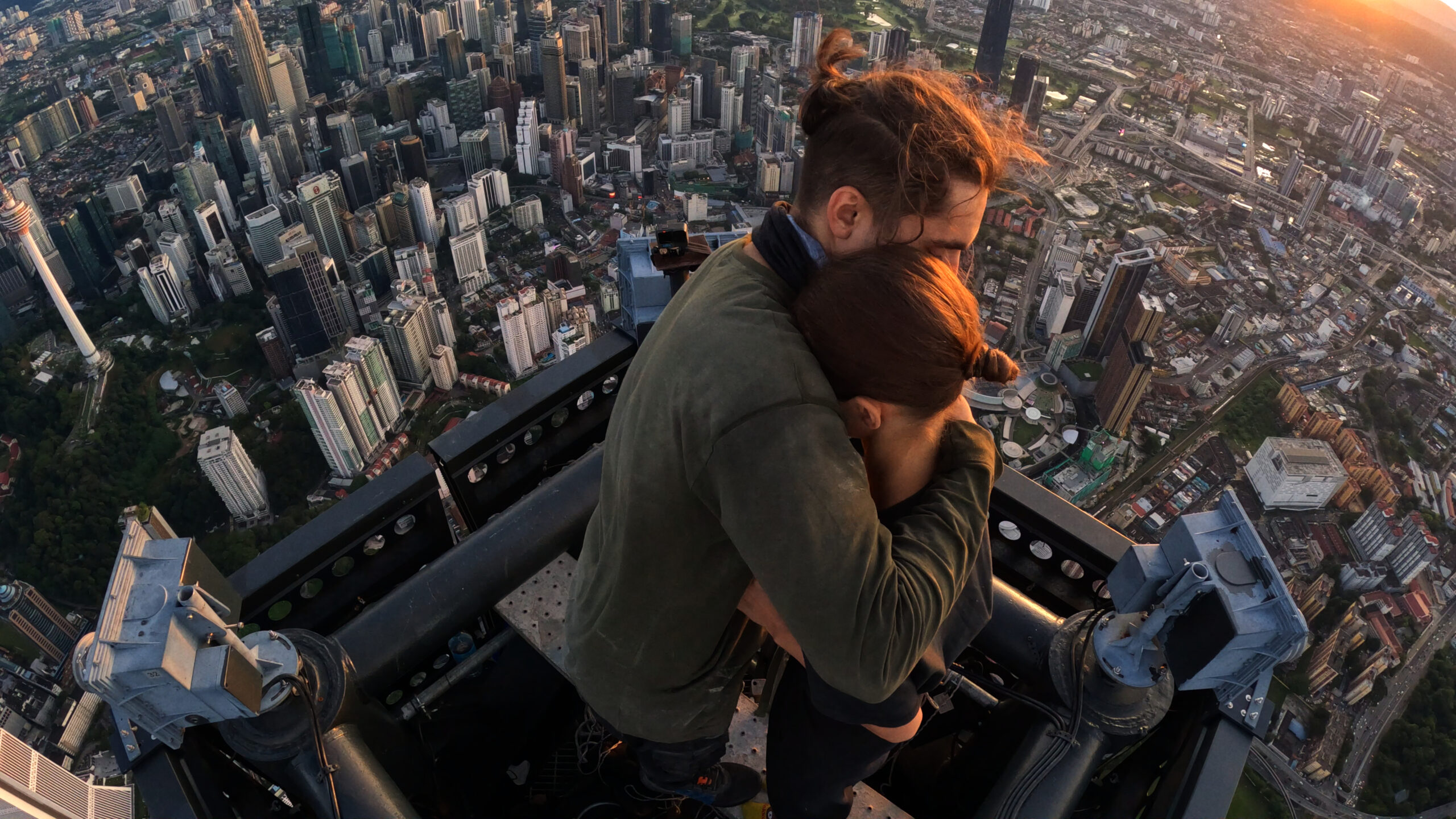 a couple embracing at the top of a skyscraper