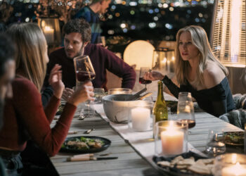 a man and woman at an outdoor dinner table