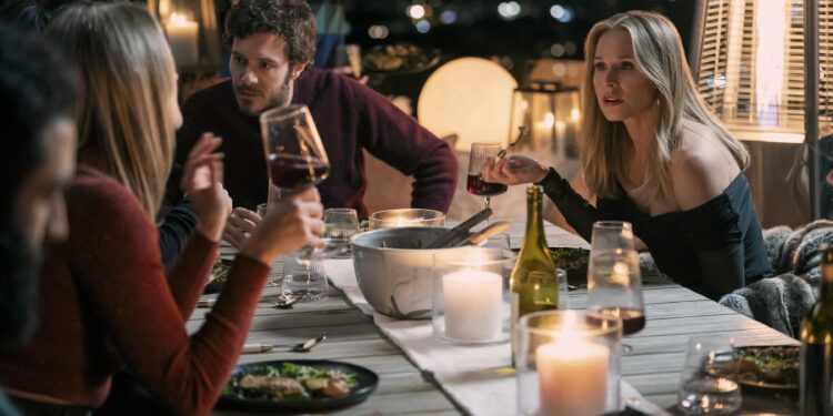 a man and woman at an outdoor dinner table