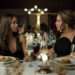two women face each other at a dining table at a restaurant