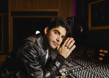 a photo of a man by a soundboard