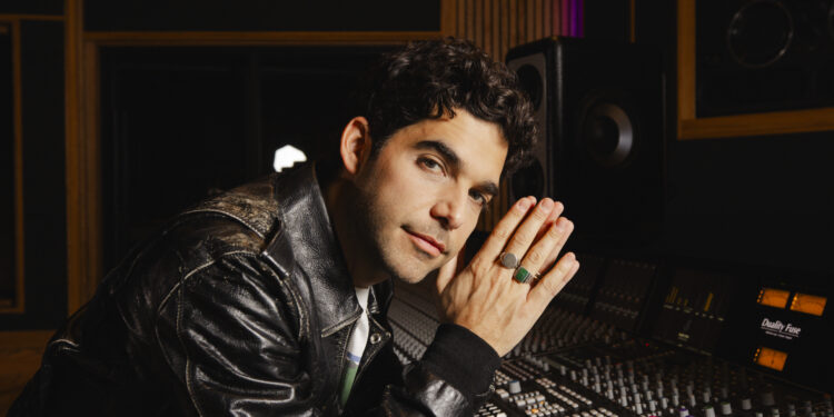 a photo of a man by a soundboard