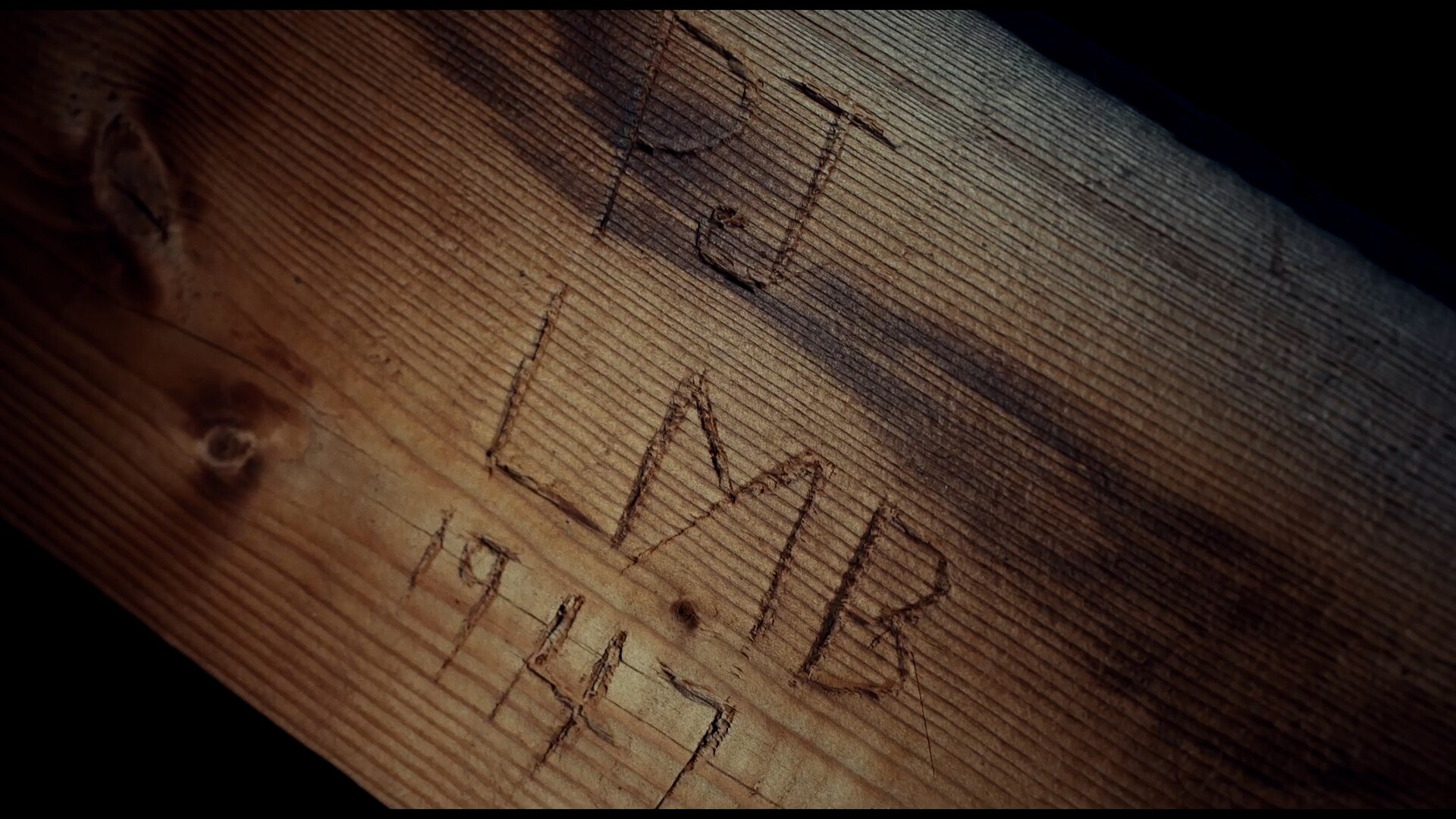 Etches in a piece of wood that says PJ LMB 1947