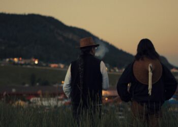 two men overlook a rural setting