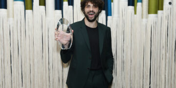 noah centineo holds an award against a scad tvfest backdrop