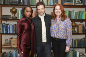 Aja Naomi King, Ben Rappaport, and Casey Kyber stand in front of a book shelf at SCAD TVfest