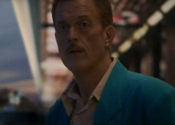 a man in a blue jacket gives a cryptic stare in Vegas