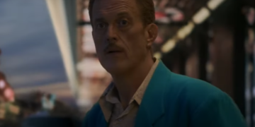 a man in a blue jacket gives a cryptic stare in Vegas