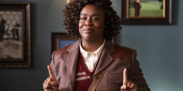 a woman with two fingers up, one on each hand