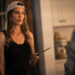hilary swank holds a knife in a kitchen