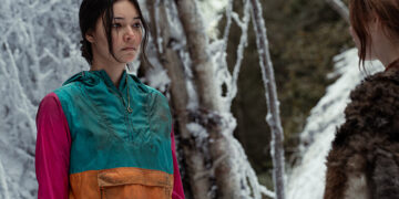 mari stands in the snow in a windbreaker