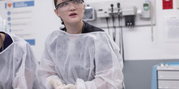 Isa Briones in scrubs as Santos on The Pitt