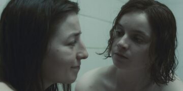 two girls in a shower staring at each other