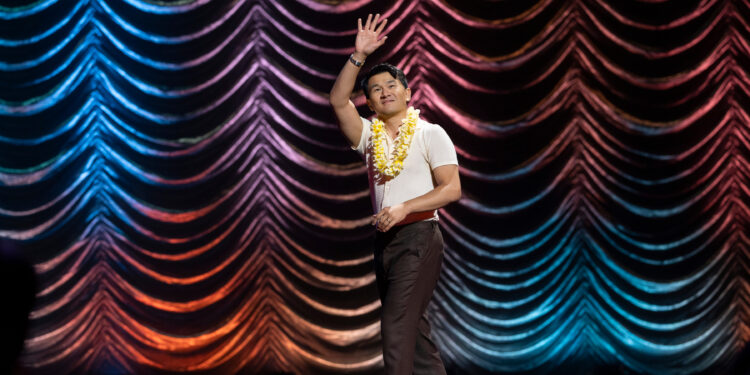 ronny chieng is on stage for his netflix special love to hate it