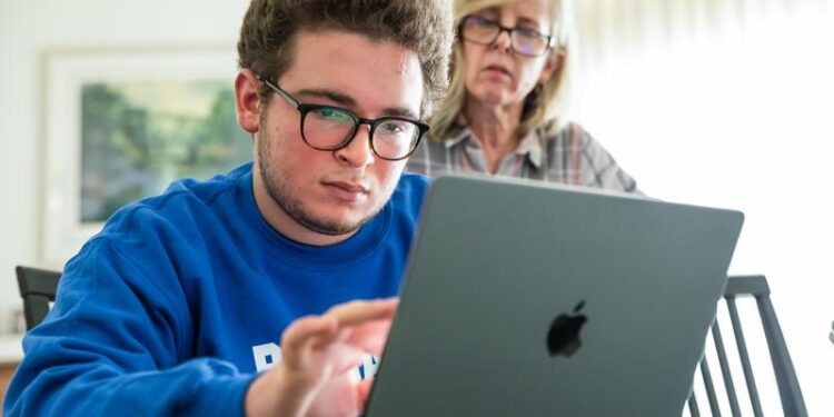 social studies documentary subject jonathan in front of a laptop