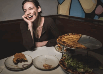 comedian chloe radcliffe at restaurant with pizza