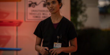 supriya ganesh the pitt's dr. mohan stands outside of the ER