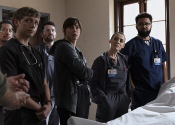 The Pitt cast stands next to a body covered in a white sheet