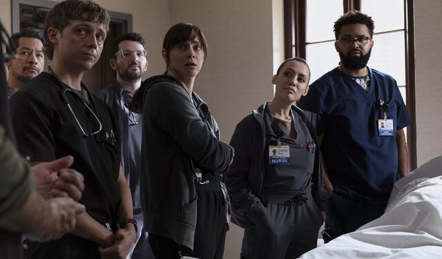 The Pitt cast stands next to a body covered in a white sheet