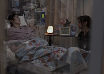 the pitt roxie actress brittany allen in a hospital bed next to actress fiona dourif