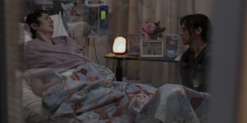 the pitt roxie actress brittany allen in a hospital bed next to actress fiona dourif