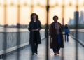 emmy rossum and quincy tyler bernstine walking on a bridge in furious on hulu
