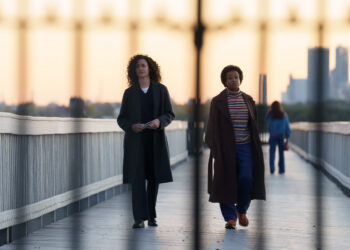 emmy rossum and quincy tyler bernstine walking on a bridge in furious on hulu