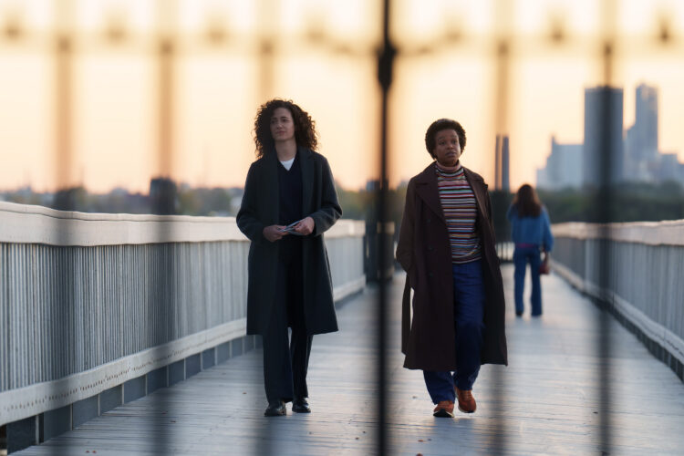emmy rossum and quincy tyler bernstine walking on a bridge in furious on hulu