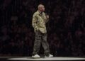 dave chappelle on stage in a colin kaepernick jacket