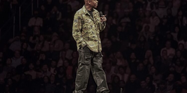 dave chappelle on stage in a colin kaepernick jacket