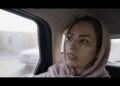 tehereh sits in the back of a taxi in iran in an eye for an eye documentary