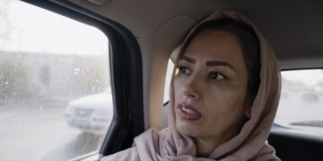 tehereh sits in the back of a taxi in iran in an eye for an eye documentary