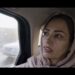 tehereh sits in the back of a taxi in iran in an eye for an eye documentary