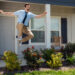 Ted lasso leaps in the air outside of a house