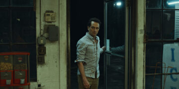 matthew rhys as tom loftis enters a convenience store on widow's bay