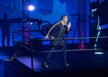 David Harbour in a track suit on stage for DTF St. Louis