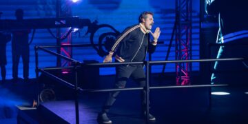 David Harbour in a track suit on stage for DTF St. Louis